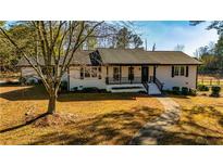 Ranch home with white exterior, black trim, and a landscaped yard at 3625 Pointer Rd, Loganville, GA 30052