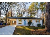 Charming single-story home with a bright blue front door and covered parking at 474 Fairlock Nw Ln, Atlanta, GA 30331