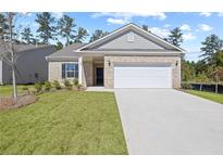 Charming single-story home with brick facade, two car garage, and well-manicured lawn at 476 Village Ln, Fairburn, GA 30213