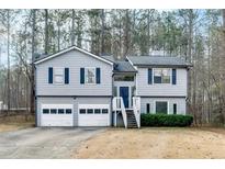 Split level home with a 2-car garage and a staircase leading to the front door at 336 Adelene Way, Dallas, GA 30157
