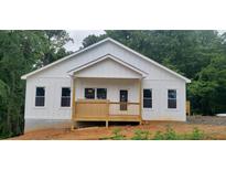 Charming new construction home with white siding, covered front porch, and beautifully wooded surroundings at 41 Walnut Trl, Cartersville, GA 30121