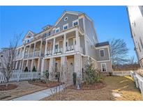 Charming two-story home with stone accents, inviting front porch, and manicured landscaping at 646 Brashy St, Woodstock, GA 30188