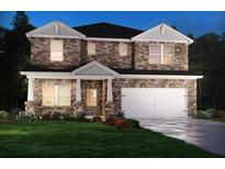 Two-story stone home featuring a two-car garage, covered porch, and manicured lawn at 6900 Winchester Pl, Fairburn, GA 30213