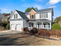 Charming two-story home featuring a two-car garage, inviting front porch, and beautifully landscaped front yard at 2352 Kelman Pl, Dacula, GA 30019