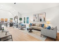 Open living area with hardwood floors, stylish furniture, and large windows at 1257 Eason Nw St, Atlanta, GA 30314