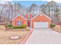 Brick ranch home with red shutters, attached garage, and landscaped yard at 700 Brambling Way, Stockbridge, GA 30281