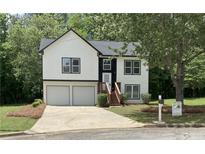 Charming two-story home featuring a two-car garage, well-manicured lawn, and inviting front entrance at 2655 Brandenberry Dr, Decatur, GA 30034