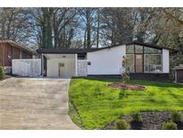 Ranch style home with modern exterior and landscaped lawn at 2592 Baker Nw Rd, Atlanta, GA 30318