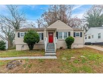 Charming ranch home with red door and landscaped yard at 1360 Lockhaven Sw Cir, Atlanta, GA 30311