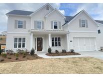 Beautiful two-story home with painted brick exterior and manicured front yard at 3345 Hillshire Dr, Cumming, GA 30028