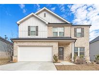 Charming two-story home with a two car garage, attractive brickwork, and a covered entry at 304 Bowfin Trl, Mcdonough, GA 30253