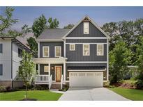 Two-story home with gray siding, white trim, and a covered porch at 414 Langford Dr, Norcross, GA 30071