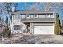Two-story gray house with white garage door and stone accents at 3988 Centennial Trl, Duluth, GA 30096