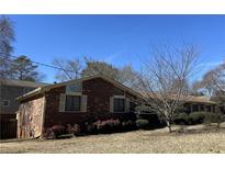 Charming brick home with mature landscaping and a well-maintained front yard at 3557 Clubhouse Ln, Conyers, GA 30094