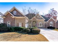 Two-story house with brick and siding, landscaping, and a paved driveway at 2041 Democracy Dr, Buford, GA 30519