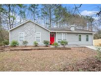 Gray house with red door and stone accents at 5632 Rock Springs Rd, Lithonia, GA 30038