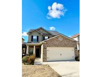 Two-story house with brick and siding exterior, two-car garage, and landscaping at 6255 Hickory Lane Cir, Union City, GA 30291