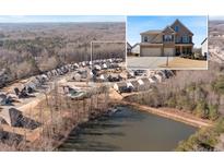 A picturesque aerial view showcases the community and pond, highlighting the prime real estate location of the home at 5915 Partners Pass, Cumming, GA 30028