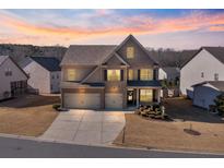 Beautiful two-story home with a three car garage and manicured landscaping at 5915 Partners Pass, Cumming, GA 30028