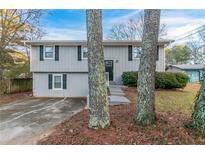 Gray two-story house with gray trim and landscaping at 2098 Mallard Crst, Lithonia, GA 30058