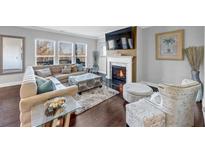 Cozy living room featuring a fireplace, plush seating, hardwood floors and sun-filled windows at 4349 Northmark Ln, Buford, GA 30518