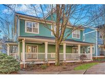 Charming two-story home with a front porch and landscaped yard at 225 Carlyle Park Ne Dr, Atlanta, GA 30307