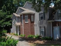 Two-story house with gray siding, brick accents, and attached garage at 2700 Pierce Brennen Ct, Lawrenceville, GA 30043