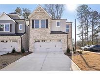 Two-story brick townhome with gray accents and a two-car garage at 4195 Waratah Way, Mableton, GA 30126