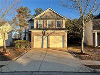 Charming two-story home featuring a brick facade and attached two-car garage at 105 Birch St, Hiram, GA 30141