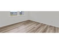 This bedroom features durable hardwood flooring and a bright window at 3340 Redwood Ct, Covington, GA 30016