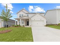 Charming two-story home with manicured lawn, inviting front porch, and attached two-car garage at 3340 Redwood Ct, Covington, GA 30016