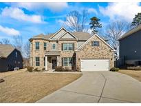 Brick two-story house with a large driveway and landscaped yard at 3330 Deaton Trl, Buford, GA 30519