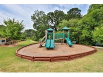 Community playground featuring slides and a play structure for outdoor fun, with surrounding greenery and benches at 3330 Deaton Trl, Buford, GA 30519