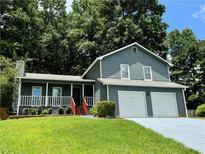 Charming home with a well-manicured lawn, inviting front porch and a two car garage at 3945 Peninsula Ct, Lawrenceville, GA 30044