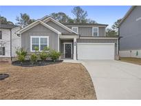 Charming two-story home with a well-manicured lawn, a two-car garage, and attractive curb appeal at 5 Dew Drop Pt, Dallas, GA 30157