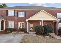 Charming brick townhome with well-maintained landscaping and a welcoming entrance at 3750 Magnolia Walk Trl, Cumming, GA 30040