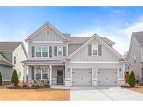 Charming two-story home featuring a two-car garage, covered porch, and neutral gray siding at 3330 Harmony Hill Rd, Kennesaw, GA 30144