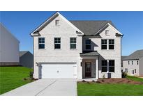 Charming two-story home features a white brick facade, attached garage, and well-manicured front lawn at 313 Chattahoochee Cir, Locust Grove, GA 30248