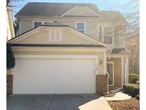 Two-story house with attached garage and landscaping at 2024 Appaloosa Way, Conyers, GA 30012