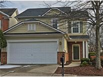 Two-story house with a white garage door and brick accents at 2024 Appaloosa Way, Conyers, GA 30012