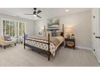 This bedroom features carpet floors, a four-poster bed, natural light, and neutral paint at 4521 Twinberry Dr, Powder Springs, GA 30127