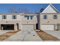 Three-unit townhome building, brick and siding exterior, two-car garages at 4529 Twinberry Dr, Powder Springs, GA 30127