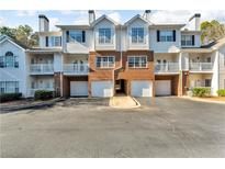 Brick front of townhome with attached garage and balconies at 308 Spring Heights Lane # 308, Smyrna, GA 30080