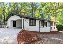 Charming single-Gathering home featuring a white brick exterior and a convenient carport at 4336 Parkview Dr, Lithia Springs, GA 30122