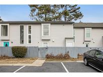 Two-story townhome with gray siding and fenced backyard at 257 Country Club Dr, Jonesboro, GA 30238