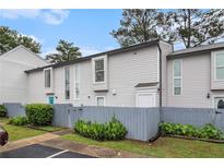 Charming townhome with a fenced yard and a manicured lawn at 257 Country Club Dr, Jonesboro, GA 30238