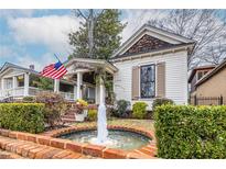 Charming white house with a wrap-around porch and fountain at 296 Logan Se St, Atlanta, GA 30312