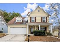 Charming yellow two-story home with attached garage and inviting front porch at 498 Anglewood Trce, Stockbridge, GA 30281