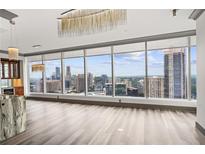 Bright living room featuring stunning skyline views and contemporary lighting fixtures at 3630 Peachtree Ne Rd # 2207, Atlanta, GA 30326