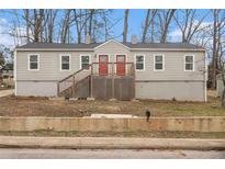 Inviting duplex with matching red doors and a shared wooden deck entrance at 3300 Russell St, Atlanta, GA 30354